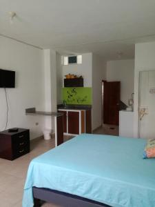 a bedroom with a bed and a desk and a television at Francisco Habitaciones in Manta +12 photos