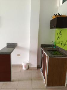 a kitchen with a sink and a counter top at Francisco Habitaciones in Manta +12 photos