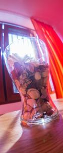 a glass vase filled with rocks on top of a table at Apartament Mamaia Luna Park in Constanţa