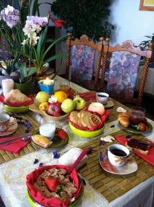 a table with plates of food and cups of coffee at Belvedere Sul Mare in Quartu SantʼElena