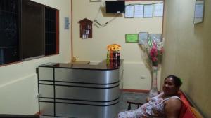 a woman sitting in a chair in a hospital room at Hospedaje Marvento in Pucallpa