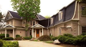 a large house with a black roof at Benmiller Inn & Spa in Goderich