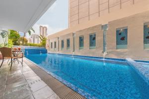 a large swimming pool next to a building at Somerset Millennium Makati in Manila