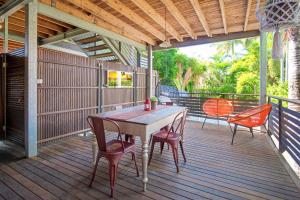 a wooden deck with a table and chairs on it at Anville Court in Brisbane