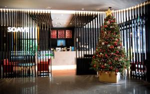 a christmas tree in the middle of a lobby at Hotel Venue-G Seoul in Seoul