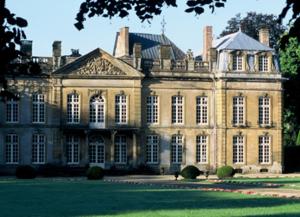 a large brick building with a large yard at Château de Bazeilles in Bazeilles