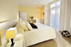a bedroom with a large white bed and a window at The Traill in Margaret River Town