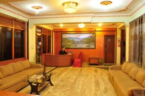 a lobby with a man standing at a desk at Hotel Brihaspati in Kathmandu