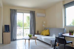 a living room with a couch and a table at Athena Holiday Homes in Limassol