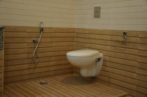 a bathroom with a toilet and a shower at Hotel Ocean Heritage in Kanyakumari