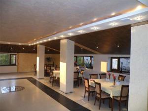 a dining room with tables and chairs in a building at Capital Hotel in Yerevan