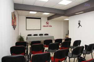 a room with chairs and a table and a screen at Gran Via in Burgas City
