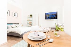 a dining room with a table with plates and silverware at Chill apartments in Prague