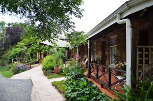 a house with a porch with plants on it at Country Lane Guesthouse in Howick