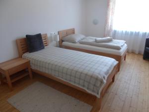 a bedroom with two beds and a chair at Schottar FeWo ST 09 in Dornbirn