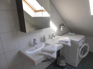 a bathroom with a sink and a toilet and a mirror at Schottar FeWo ST 09 in Dornbirn