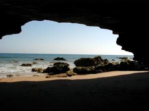 a view of the ocean from a cave on a beach at Hostal Mar de Frente in Los Caños de Meca