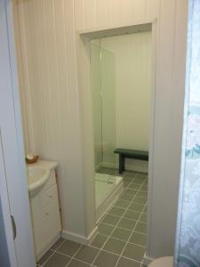 a bathroom with a shower and a sink and a mirror at The Northwood in Colwyn Bay