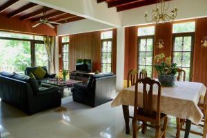 a living room with a table and chairs at Symphony Villa in Nai Harn Beach