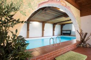 an indoor swimming pool with an archway in a house at Pension Singer in Innsbruck