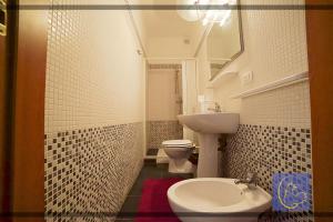 a bathroom with a sink and a toilet and a mirror at BB Gallipolis Terra in Gallipoli
