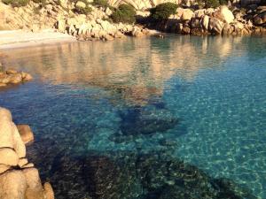 a large body of water with rocks in it at Stella di Mare in La Maddalena