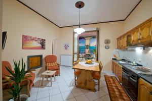 a kitchen with a table and chairs in a room at Casa Generosa in Agerola