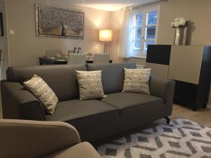 a living room with a couch and a table at L'appart du Cloitre in Albi