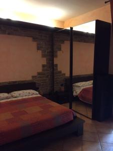 a bedroom with two beds and a brick wall at Comfort in Scandicci