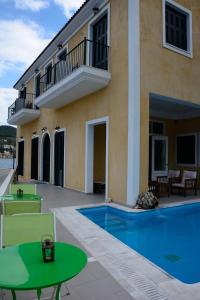 a villa with a swimming pool and a patio at Lazaretto Palace in Vathi