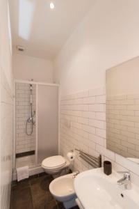 a white bathroom with two sinks and a toilet at Flaminia - B&B Tevere Home "Bed your Breakfast" in Rome