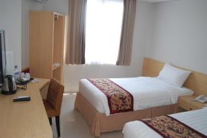 Postel nebo postele na pokoji v ubytování Bekizaar Hotel Surabaya + 32 fotografií
