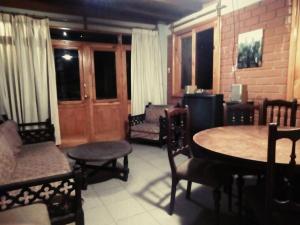 a living room with a table and chairs at Beautiful House in Heart of Pachacamac in Pachacamac