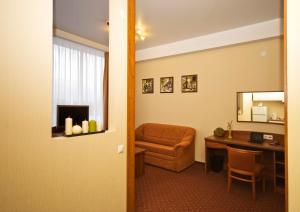 a room with a desk and a chair and a mirror at Apart Hotel in Ryazan