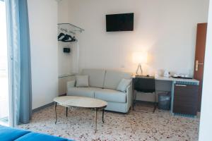a living room with a couch and a desk at Dimore Le Lucane in Matera
