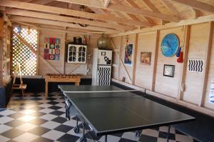 a ping pong table in the middle of a room at Villa Kitrini in Kyparissia