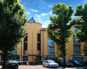 a building with cars parked in front of it at Residenza Le Cupole in Parma