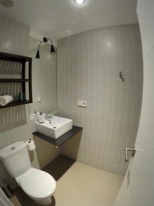 a bathroom with a toilet and a sink at Cerro Mar in El Cerro Blanco