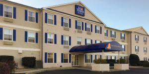 a hotel with a blue sign on the front of it at InTown Suites Extended Stay Anderson SC - Clemson University in Anderson