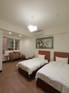 Postel nebo postele na pokoji v ubytování Long Zhi Yue Hotel