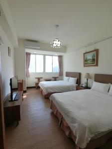 Postel nebo postele na pokoji v ubytování Long Zhi Yue Hotel