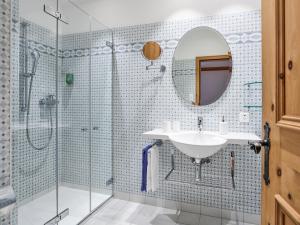 a bathroom with a sink and a shower with a mirror at Hotel Privata in Sils Maria