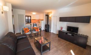 a living room with a couch and a table at Serena Charme Green Holiday in Ledro