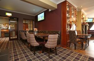 a dining room with a table and chairs at Newburgh Inn in Ellon