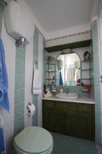 a bathroom with a toilet and a sink and a mirror at Sara Accommodation in Tropea
