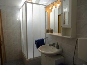 a bathroom with a sink and a mirror at Apartment Marija in Tisno