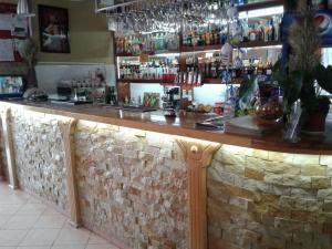 a bar in a restaurant with a stone wall at Hotel Fiyesta in Starokostyantyniv