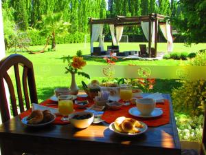 a table with breakfast food and orange juice on it at Pilgrim's Rest - Descanso del Peregrino in Chacras de Coria