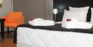 Ένα ή περισσότερα κρεβάτια σε δωμάτιο στο Ubay Hotel