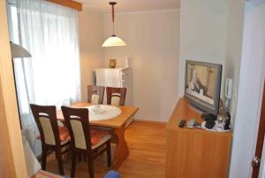 a kitchen and dining room with a table and a television at Vila Park in Rogaška Slatina